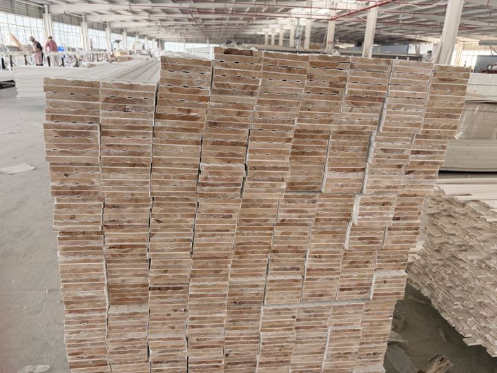 Stacks of finished wood profiles prepared on the factory floor