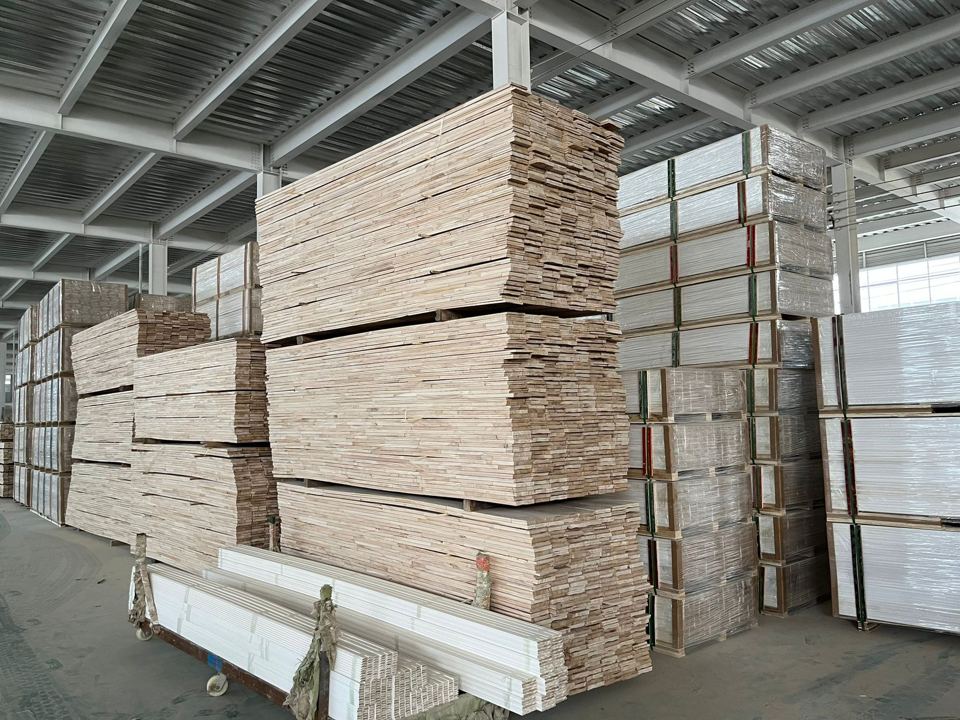 Factory storage area with stacked wood stock for moulding production