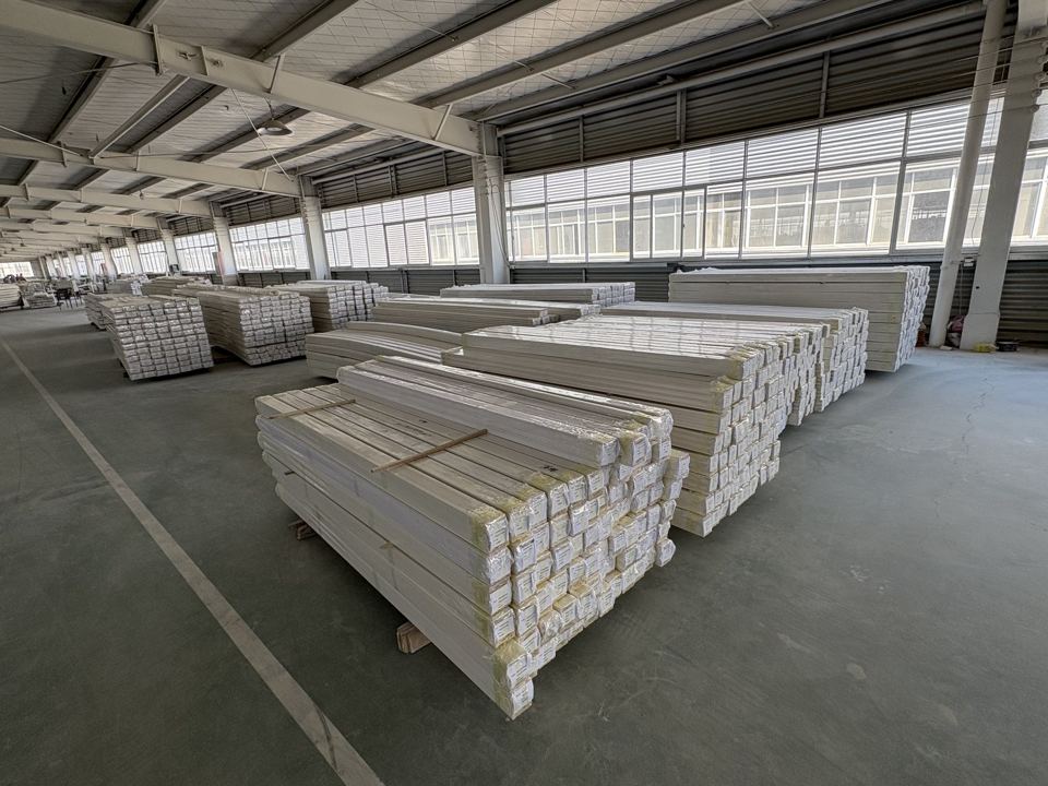 Finished primed moulding bundles staged in the factory warehouse